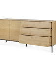 The Ethnicraft Whitebird Sideboard - 71 features solid oak, two left-side cabinet doors, three right-side drawers, and slim black metal legs for a modern look.
