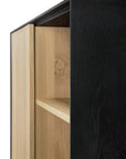 Close-up of the Ethnicraft Blackbird Storage Cupboard, showcasing its natural European oak interior and sleek dark exterior with a highlighted corner and interior shelf.