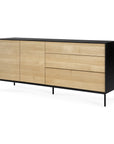 The Ethnicraft Blackbird Sideboard (2 doors + 3 drawers) features a black frame and legs, European oak cabinet doors and drawers, and a minimalist design.