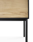 Close-up of Ethnicraft’s Blackbird Sideboard - 3 door, featuring European oak and black metal legs for a sleek, modern look.