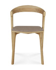 The Ethnicraft Bok Dining Chair - Oak with Warm Grey Fabric features a curved backrest and warm grey upholstered seat. Shown front-facing on a white background, its solid oak build highlights minimalist, modern elegance.
