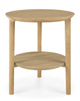 The Ethnicraft Bok Side Table - Oak features a round solid oak top, three legs, and a lower circular shelf below the tabletop, all set against a white background.