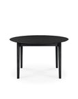 The Ethnicraft Bok Round Extendable Dining Table in black features four legs, is crafted from solid wood, and is shown against a plain white background.