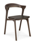 The Ethnicraft Bok Dining Chair - Brown Oak with Leather features a curved backrest, open lower back, and black leather seat. Its minimalist design includes four angled legs crafted from solid oak in a rich brown finish.