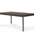 The Ethnicraft Bok Extendable Dining Table in brown oak features a minimalist rectangular design with sleek legs, crafted from solid oak, and is shown against a white background.