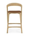 The Ethnicraft Bok Counter Stool is a modern wooden barstool with a curved backrest and a brown cushioned seat, shown from the front against a white background.