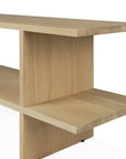 The Ethnicraft Kabuki Side Table in oak features a minimalist design with intersecting flat panels, open shelves, and clean lines, crafted from solid oak with a light finish.