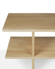 The Ethnicraft Kabuki Side Table - Oak is a minimalist wooden piece crafted from solid oak, featuring two rectangular shelves and a central vertical divider, shown on a white background.