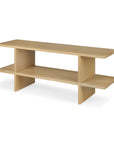 The Kabuki Side Table - Oak by Ethnicraft showcases a modern, minimalist design in solid oak, featuring a rectangular top, open central shelf, and vertical supports.