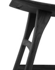 Close-up of the Ethnicraft Osso Dining Stool - Black, crafted from black-stained solid oak, highlighting the smooth finish and craftsmanship of the seat and legs against a white background.