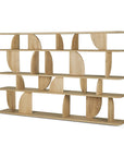 The Ethnicraft Geometric Rack - Oak is a modern solid oak bookshelf with four shelves and abstract curved and straight vertical dividers, finished in light natural tones for an open, artistic look.