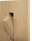 Close-up of the Utilitile Wall Hanger by Ethnicraft, featuring a minimalistic light wood panel with a rectangular peg partially inserted into a vertical slot, inspired by modern design.