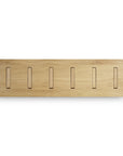 The Ethnicraft Utilitile Wall Hanger is a rectangular solid oak rack with six vertical slots in a natural light finish, ideal as a minimalistic coat hanger. Shown here against a plain white background.