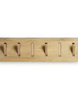 The Ethnicraft Utilitile Wall Hanger is a rectangular, minimalist solid oak design with five evenly spaced foldable hooks, shown wall-mounted against a white background and displayed with hooks in the upright position, ready for use.