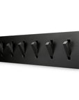 The Ethnicraft Utilitile Wall Hanger is a modern, black, wall-mounted coat rack with six fold-out hooks arranged on a solid oak rectangular base, featuring a minimalistic and signature Ethnicraft design.