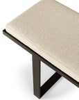 A close-up of the Ethnicraft Stability Bench features a textured cream cushion and black metal frame, highlighting European refinement and sturdy design against a white background.