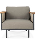 The Corbey Outdoor Lounge Chair by Ethnicraft offers a cushioned light gray seat and backrest, black metal frame, and flat wooden armrests—an inviting piece to elevate your outdoor space with style.