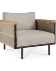 The Corbey Outdoor Lounge Chair by Ethnicraft features a black metal frame, light beige cushions, wooden armrests, and rope detailing for a minimalist look—ideal for elevating your outdoor space.