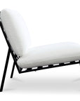 Side view of the Salma Outdoor Lounge Chair by Moes, featuring a black metal frame with angled legs and thick quick-dry foam cushions in white Olefin fabric, set against a white background.