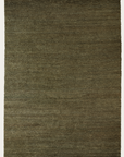 A rectangular Mojave Rug - Laurel by Armadillo&Co in olive green features a smooth, subtly textured surface with short fringe along the ends, reflecting the brands signature style.