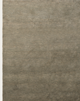 The Armadillo&Co Corsica Rug - Saltbush is a large, rectangular wool rug in solid light brown with subtle horizontal striations and slight texture, hand-knotted and shown on a white background.