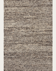 The Faroe Rug - Muscovado by Armadillo&Co is a rectangular hand-knotted wool area rug featuring a textured, speckled pattern in beige, brown, and gray for a modern, neutral look.