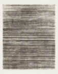 The Odessa Rug - Zinc by Armadillo&Co is a rectangular hand-knotted piece featuring subtle stripes in varying gray tones, from light to dark, for a soft, textured look.