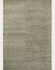 The Meadow Rug - Pistachio by Armadillo&Co is a rectangular wool rug with a subtle, speckled texture in gray and beige tones, featuring a simple, minimalist design on a plain white background.