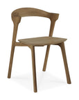 The Ethnicraft Bok Dining Chair in Natural Teak features a minimalist design with a curved backrest, clean lines, slightly angled legs, and is crafted from FSC-certified solid teak for a modern and natural look.