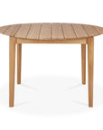 The Ethnicraft Bok Outdoor Round Dining Table in natural teak features a slatted solid teak top and four sturdy legs, shown against a white background.