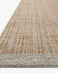 Close-up of the Cornwall Rug - Lt Grey / Natural by Loloi, featuring a textured woven jute and wool edge in neutral tones, displayed against a white background for a natural, organic look.