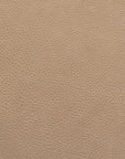Close-up of a light brown, textured leather surface with fine, natural grain patterns—part of the Wooden Stories Fabric + Leather Swatches collection, which offers fabric samples and custom made-to-order options.
