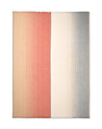 The Carte Postale Throw - Red Grey by Elvang Denmark features a rectangular design with a vertical split: the left side fades from tan to coral, the right transitions from cream to gray, and subtle fringe edges complete the look.
