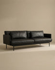 The SOBU Cherry Sofa | Leather is a modern black leather 3-seater with slim metal legs and Danish-inspired lines, shown against a beige backdrop—an ideal fit for contemporary living spaces.