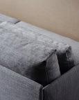 A close-up of the backrest and cushions of the Cherry Sofa 79" | Fabric by Wooden Stories in gray fabric, shown against a light beige wall—ideal for modern interiors.