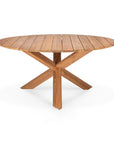 The Ethnicraft Circle Outdoor Dining Table in natural teak features a round slatted top and intersecting X-shaped base, crafted from FSC certified teak, shown against a white background.