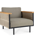 Transform your outdoor space with the Corbey Outdoor Lounge Chair by Ethnicraft, designed with light brown cushions, a black metal frame, wooden armrests, and beige rope accents.