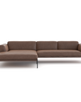 The Wooden Stories Department Modular Sofa | Leather • M4 is a modern brown sectional with a left-side chaise, minimalist design, and slender black metal legs, inspired by Danish collections and shown against a white background.