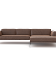 The Wooden Stories Department Modular Sofa | Leather • M4 features a modern brown design with thin metal legs and a right-side chaise lounge, inspired by Danish collections and set against a plain white background.