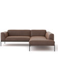 The Department Modular Sofa | Leather • M5 by Wooden Stories features brown leather upholstery, black metal legs, a right-side chaise lounge, and Danish-inspired design, shown here against a plain white background.