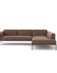The Department Modular Sofa | Leather • M6 by Wooden Stories is a modern brown L-shaped sectional with slim black metal legs, soft cushions, and a Danish-inspired minimal design, displayed against a plain white background.