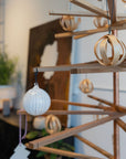 The SOBU Immortal Christmas Tree, crafted from recycled wood and decorated with wooden ornaments, a white bauble, and a tree-shaped ornament, offers a stylish and sustainable touch to your modern indoor Christmas celebration.