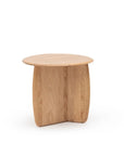The Eden Side Table by Wooden Stories features a small, round solid American oak top and two intersecting curved legs, showcasing Scandinavian simplicity and modern minimalist design. Displayed against a plain white background.