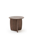 The Eden Side Table by Wooden Stories is a small, round, dark solid wood table with a smooth top and intersecting base, inspired by Scandinavian design and photographed on a plain white background.