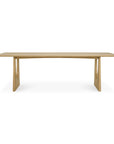 The Ethnicraft Geometric Dining Table - Oak is a modern, rectangular table with rounded edges and two wide, angled legs, shown against a white background.