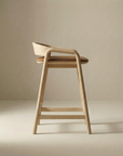 The Inlay Counter Stool | Leather Seat by Wooden Stories features a solid oak frame, curved backrest, and tan leather seat, shown against a neutral beige background.