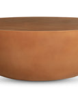 The Insitu Coffee Table by Moes features a round, half-sphere design in smooth, matte terracotta-colored concrete—perfect for contemporary decor and striking against a white background.