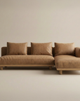 The Islet Modular Sofa | Leather • M3 by Wooden Stories is a modern, minimalist brown sectional with three seat and back cushions, plus a right-side chaise, displayed against a plain beige background.