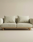 The Islet Sofa | Fabric by Wooden Stories is a modern, minimalist beige sofa with customizable upholstery, two large seat and back cushions, and rests on a solid oak platform with wooden armrests.