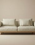 The Islet Sofa | Fabric by Wooden Stories, featuring customizable upholstery and wooden legs, brings a modern, minimalist touch to neutral interiors with its beige modular design.